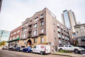 An old building on a city street with parked cars